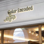 Color Encoded Logo on shop front black with light behind effect